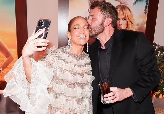 Jennifer Lopez receives a kiss from her proud husband Ben Affleck as she shares a glimpse of the wild afterparty following Shotgun Wedding premiere