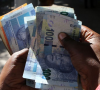 South African shares shrug banking crisis, rand slips